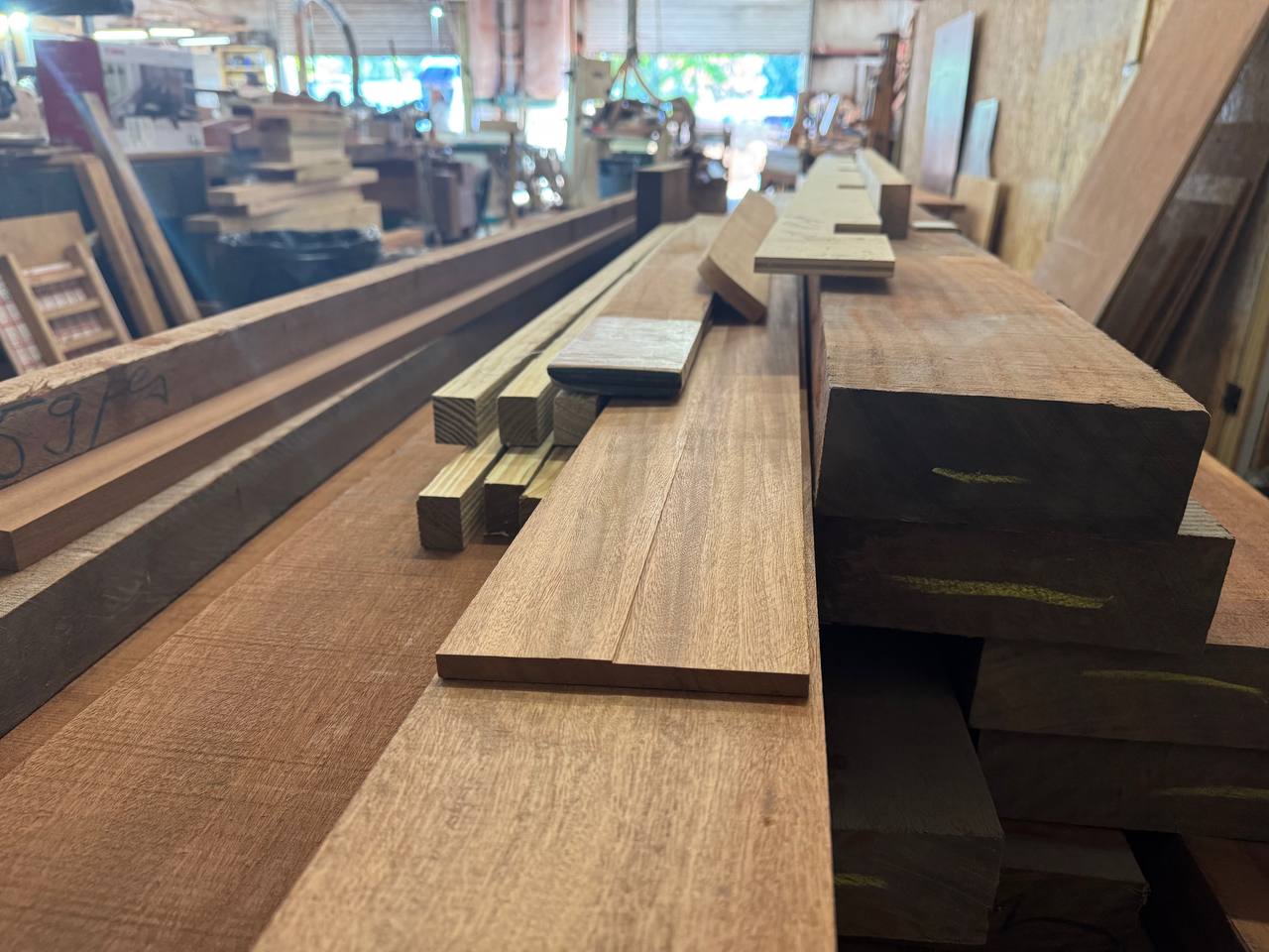 Dressed Sapele boards laid out down the length of the shop