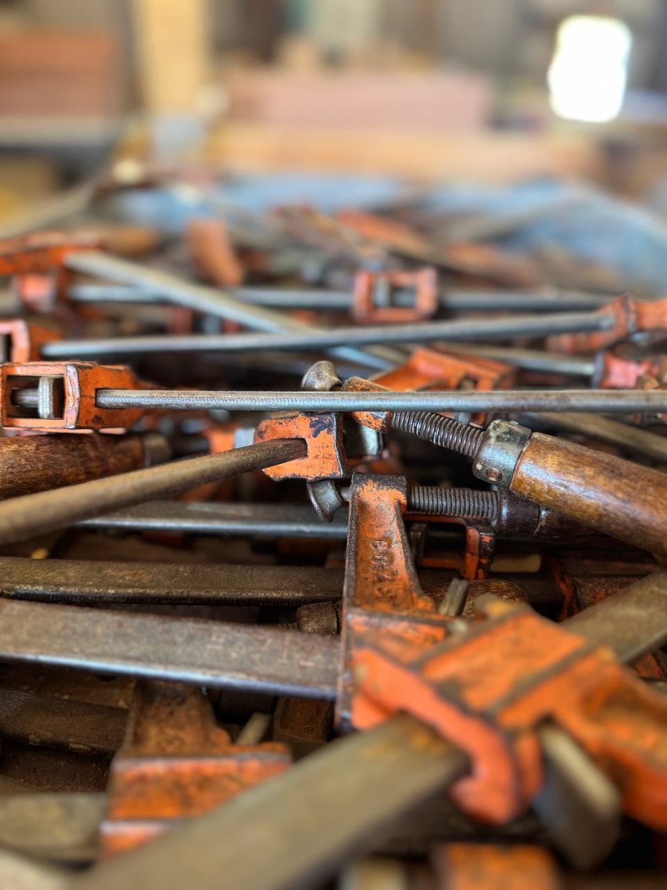 Bar clamps in the J&P Woodcrafters shop near Charleston, South Carolina — the same clamps that hold a cutting board glue-up together while it dries