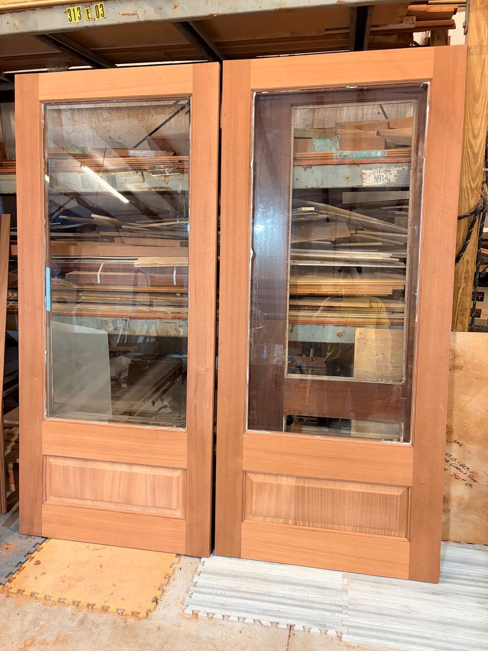 A handcrafted Sapele entry door with glass panels built by J&P Woodcrafters, showing how glass placement shapes light and sightlines